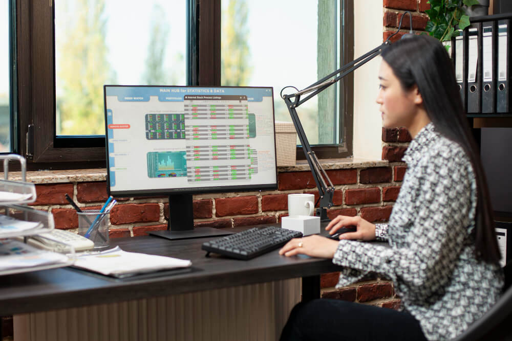 Accounting professional reviewing financial data and business reports on computer